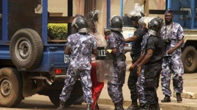 Riot policemen arrest an opposition protester in Lome on August 21, 2012.
