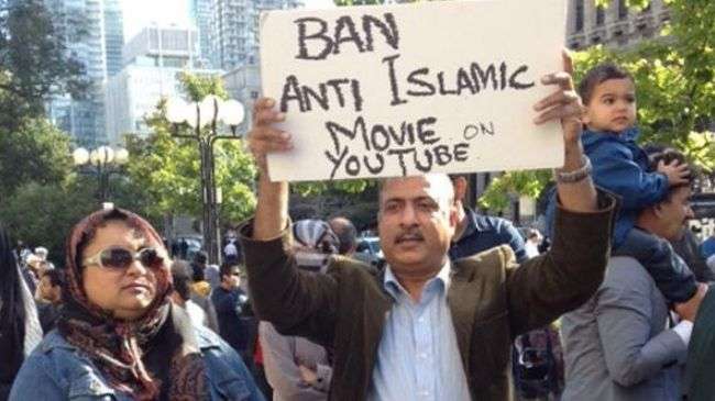 A man hold a sign during a demonstration against a US-made anti-Islam film outside the US consulate in Toronto, Canada, on September 22, 2012.