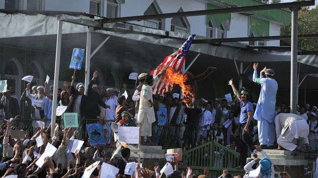 Afghan demonstrators burn an effigy of US President Barak Obama and a US flag during a protest against an anti-Islam movie and a French magazine’s sacrilegious Prophet Mohammad (PBUH) cartoons on September 21, 2012.