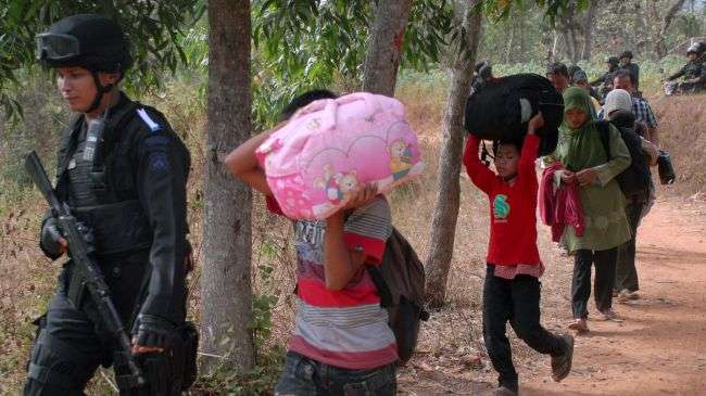 Indonesian police escort a group of Shia Muslims in the Sampang district of East Java Province, August 27, 2012.