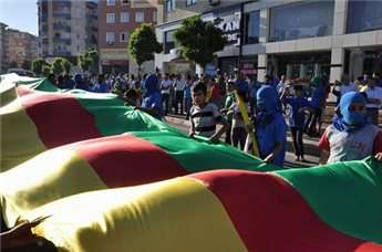 Kurds march with a giant Kurdish flag during a protest in Diyarbakir.