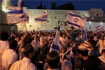 Young Israelis dance with national flags in hand in Jerusalem