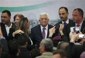 President Mahmoud Abbas stands next to Israeli MP Labor Party member Hilik Bar during a meeting with young Israelis in the West Bank city of Ramallah on Feb. 16, 2014