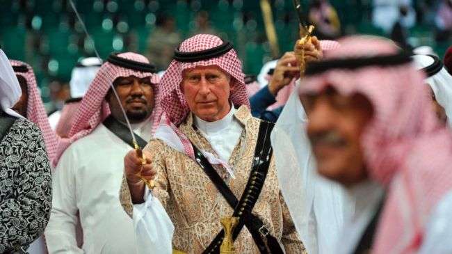 Prince Charles (C) wields a sword during a traditional ceremony in Riyadh, Saudi Arabia, on February 18, 2014.