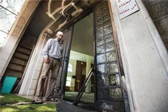 A Palestinian man stands at the entrance of a mosque in the northern Israeli city of Umm al-Faham, on April 18, 2014
