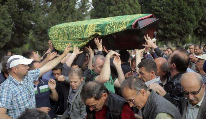 People carry the coffin of a miner who died in a fire at a coal mine during his funeral at a cemetery in Soma, a district in Turkey western province of Manisa May 14, 2014.