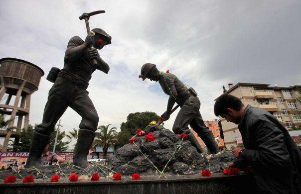 A man lays carnations at the Miners Monument in central Soma, a district in Turkey western province of Manisa May 14, 2014.
