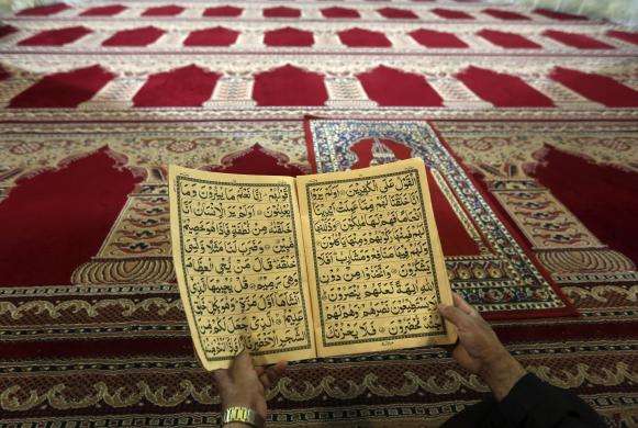 An Afghan man reads the Quran on the first day of Ramadan the holiest month in the Islamic calendar at a mosque in Kabul June 29 2014.