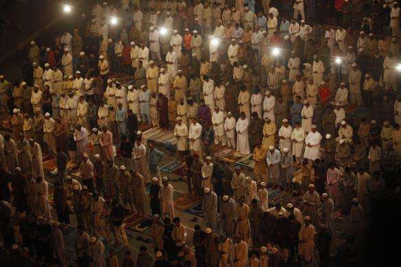 Men attend an evening mass prayer session called tarawih to mark the holy fasting month of Ramadan along a road in Karachi June 29 2014.