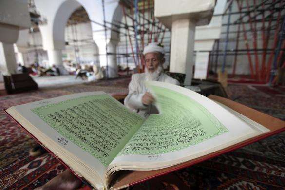 A man reads the Quran in a mosque in Sanaa Yemen June 27 2014.