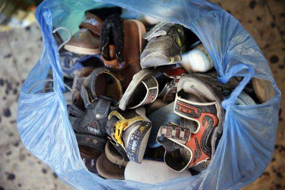 Children shoes are bagged among belongings salvaged from a damaged Palestinian home which police said was targeted in an Israeli air strike in Gaza City July 17 2014.