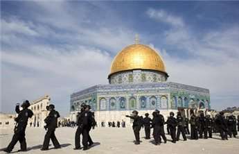 Israeli riot police stand outside the Dome of the Rock mosque during clashes with Palestinian stone-throwers (unseen) at Jerusalem