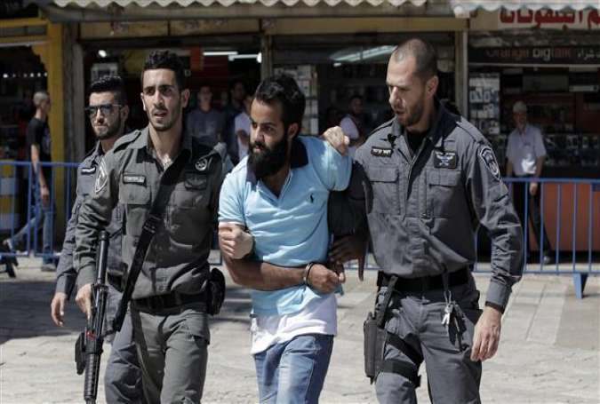 A Palestinian demonstrator is detained by Israeli forces in East al-Quds (East Jerusalem) on May 17, 2015.