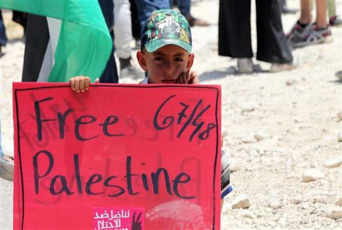 A child holds a banner during a protest against the planned demolition of the Susya village in the occupied West Bank on June 5, 2015.