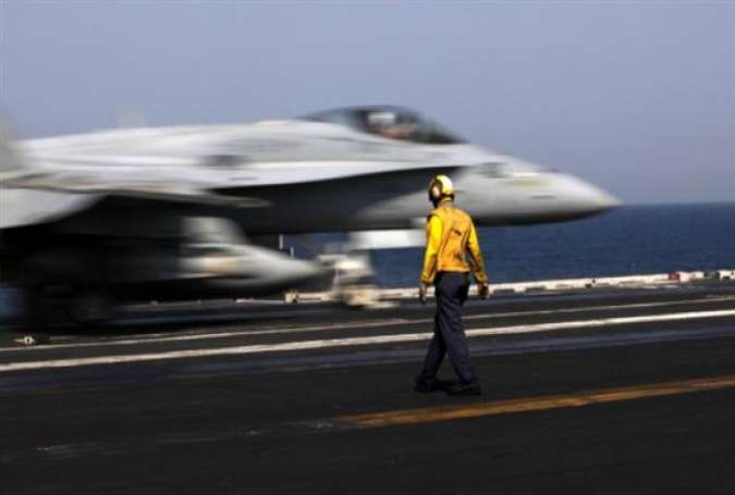 A US F/A-18 fighter jet takes off for Iraq from the flight deck of the US Navy aircraft carrier USS George H.W. Bush, in the Persian Gulf, Aug. 11, 2014.