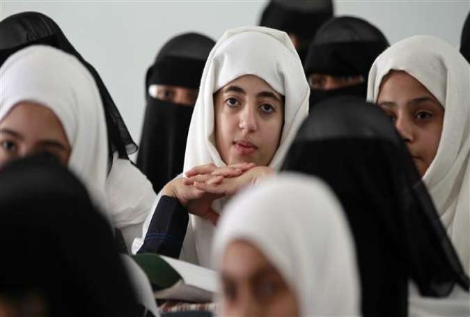 Yemeni girls attend a class in the Yemeni capital Sana’a, on August 1, 2015, as the school reopened after a four-month interruption.