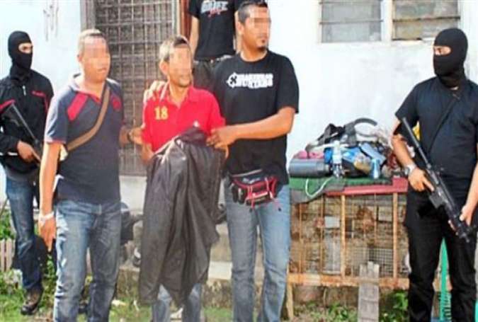 In this September 2014 photo, Malaysian security forces are seen arresting terrorist suspects in Kuala Lampur.