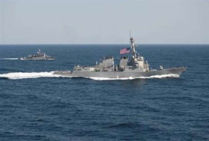 The USS Lassen (right) transits during an exercise in waters east of the Korean Peninsula in a March 12, 2015.