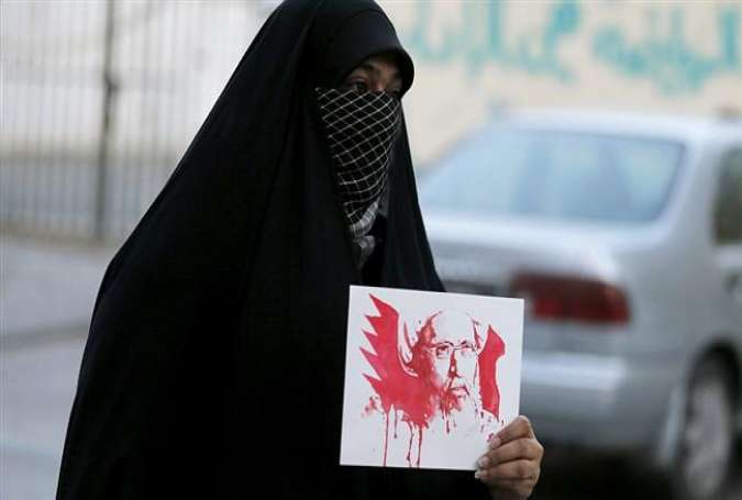 A woman holds a placard bearing a portrait of prominent Shia Muslim cleric Nimr al-Nimr during a protest in Bahrain against his execution by Saudi authorities, January 2, 2016.
