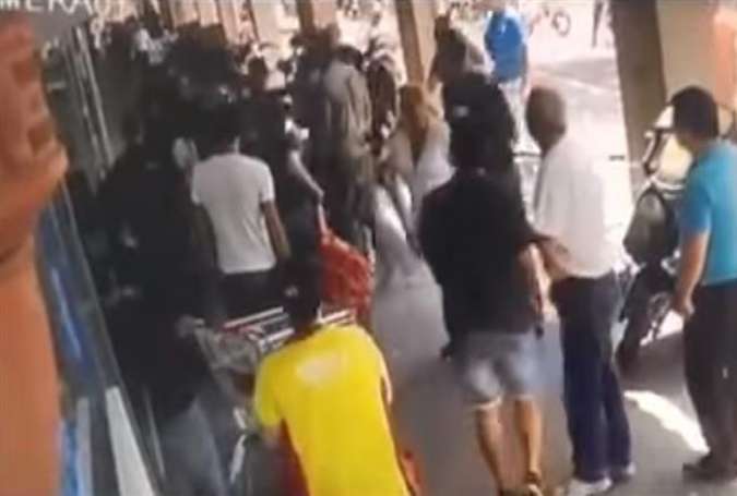This screengrab taken from a video posted online shows the scene of a brawl between Israeli border police officers and a young Palestinian man outside a supermarket in Tel Aviv, May 22, 2016.