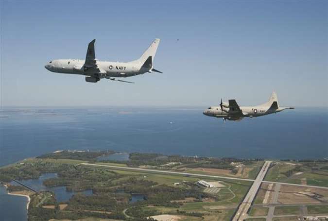 A P-8A Poseidon flying alongside a Lockheed P-3 Orion, close to Naval Air Station Patuxent River, Maryland, 2010.