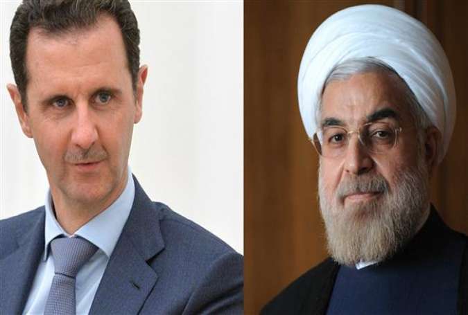 Iranian President Hassan Rouhani (R) and his Syrian counterpart Bashar al-Assad