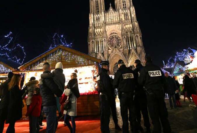 French police officers patrol at the Christmas market next to the Cathedral of Notre-Dame de Reims, in Reims, December 20, 2016.