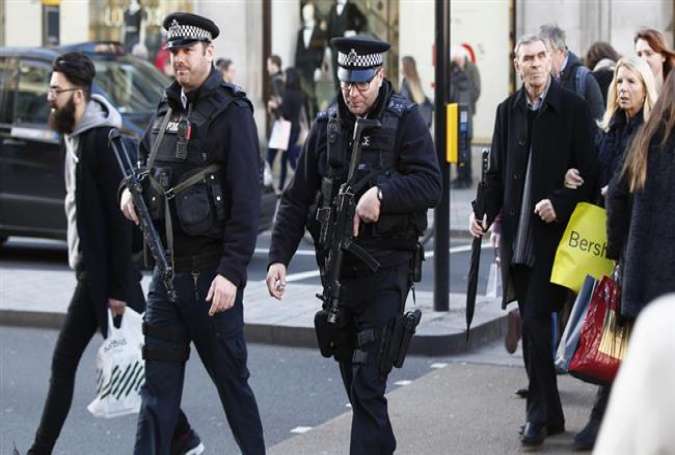Armed police walk among shoppers along Oxford Street in London.