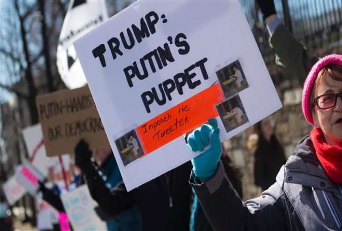 Protesters march against President Trump outside the Embassy of Russia on March 4, 2017, in Washington, DC. (Photo by AFP)