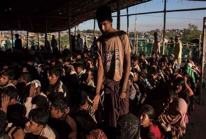 Rohingya Muslim refugees queue for relief supplies in the Kutupalong refugee camp in Cox