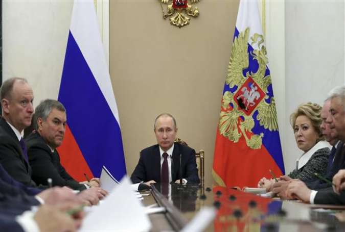 Russia’s President Vladimir Putin (C) chairs a meeting with members of the Security Council in Moscow, Russia, April 6, 2018. (Photo by Reuters)