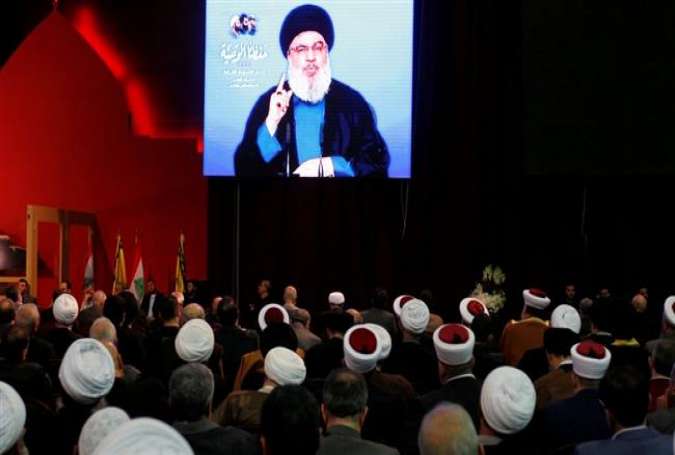 Lebanon’s Hezbollah chief Sayyed Hassan Nasrallah is seen on a video screen during an address in Beirut, February 16, 2018.