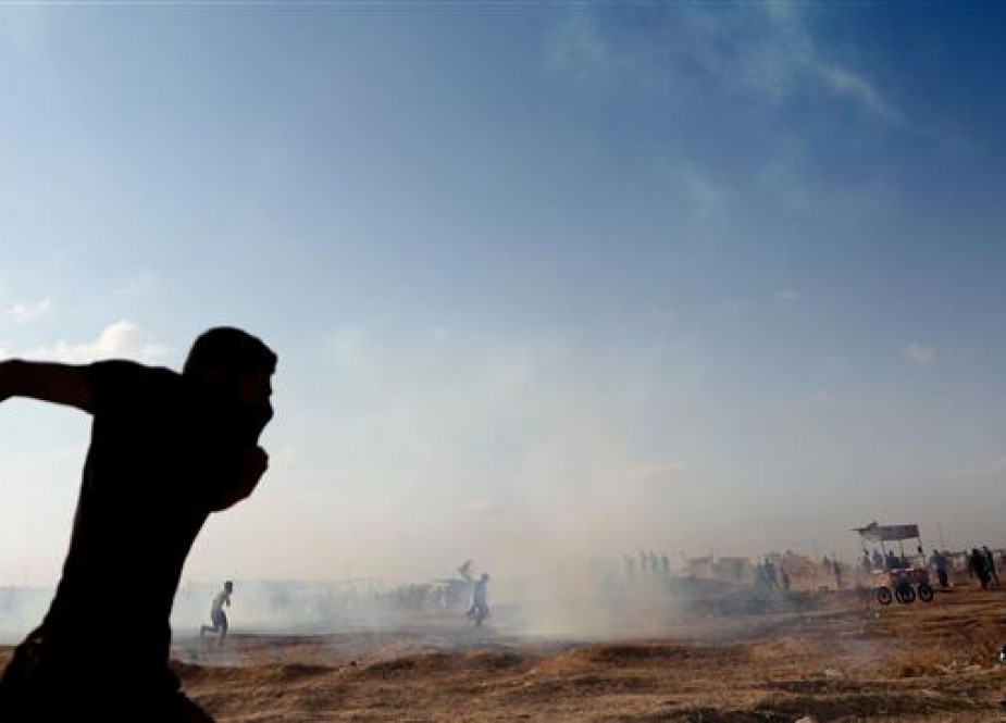Palestinians run to take cover as an Israeli drone fires tear gas grenades in Gaza City.jpg