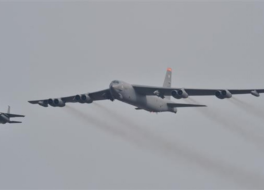 A B-52 bomber (R) being escorted by a South Korean F-15 jet (file photo)