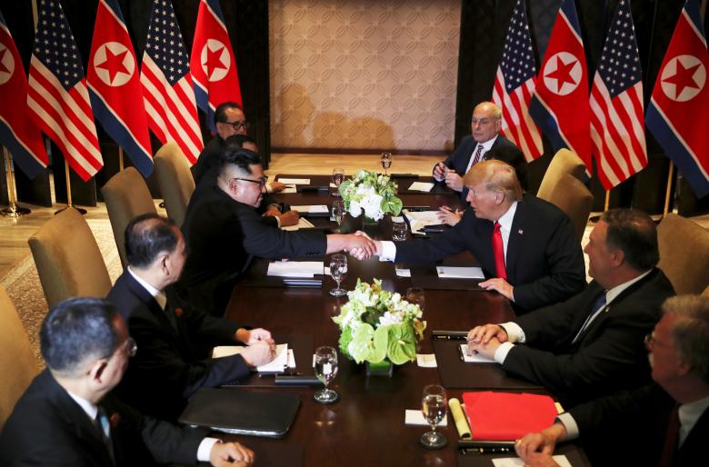 President Donald Trump shakes hands with North Korea's leader Kim Jong Un before their expanded bilateral meeting at the Capella Hotel on Sentosa island in Singapore.