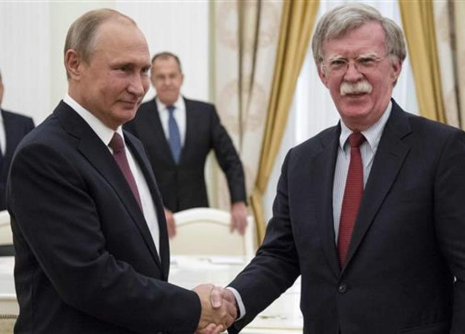 Russian President Vladimir Putin (L) shakes hands with US National Security Advisor John Bolton during their meeting in the Kremlin in Moscow on June 27, 2018. (Photo by AFP)