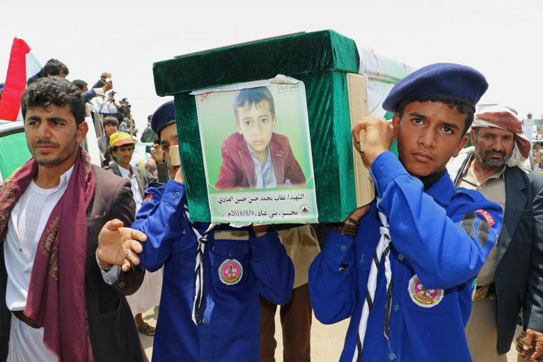 Scouts carry the coffin of a boy during the funeral of people killed in a Saudi-led coalition air strike on a bus in northern Yemen, in Saada.