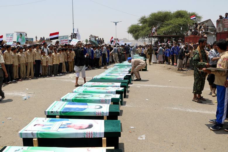 Mourners attend a funeral of people, mainly children, killed in a Saudi-led coalition air strike on a bus in northern Yemen, in Saada.