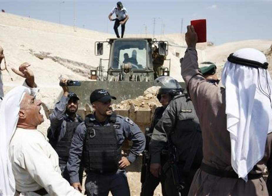 Palestinian protesters chant slogans and confront Israeli forces.jpg