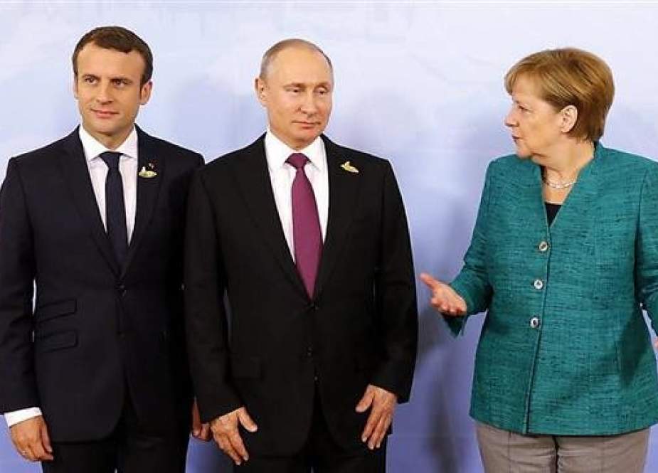 (L-R) French and Russian Presidents Emmanuel Macron and Vladimir Putin and German Chancellor Angela Merkel (Photo by Reuters)