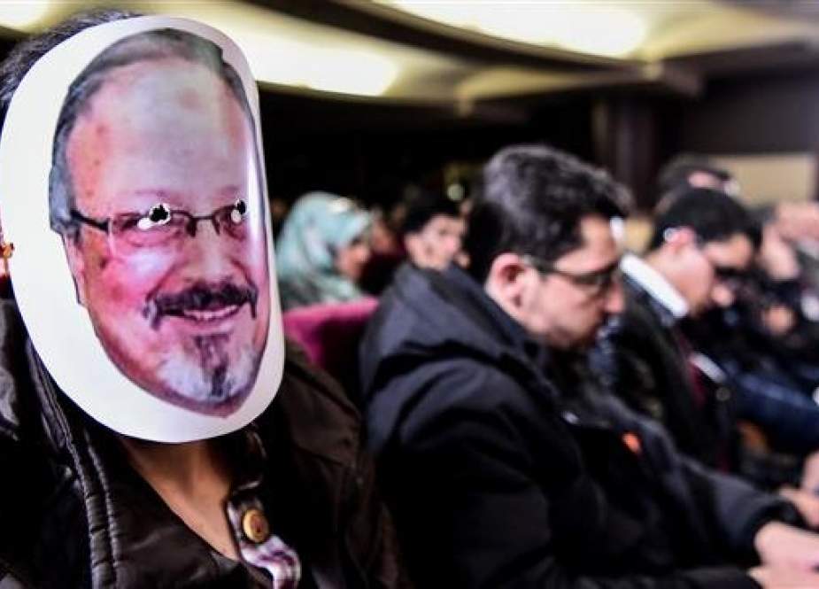 A man wears a mask of killed journalist Jamal Khashoggi during a commemoration event of Khashoggi