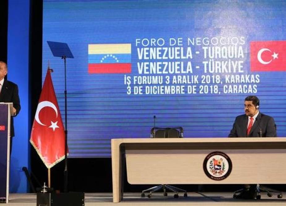 Handout picture released by Venezuela’s Presidency showing Turkish President Recep Tayyip Erdogan (L) delivering a speech while his Venezuelan counterpart, Nicolas Maduro, listens, during the Venezuela-Turkey Business Forum, in Caracas, on December 3, 2018. (Via AFP)