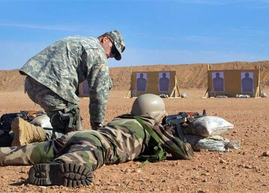 A US Army instructor is seen alongside Malian soldiers in this picture taken on April 12, 2018 at a military camp in southwestern Mali.