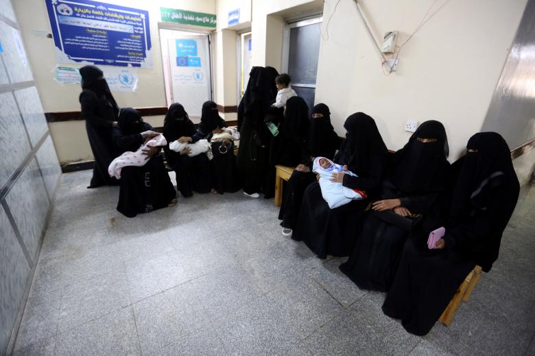 Women sit with their children at a malnutrition intensive care unit at al-Thawra hospital in Hodeidah, November 17, 2018.