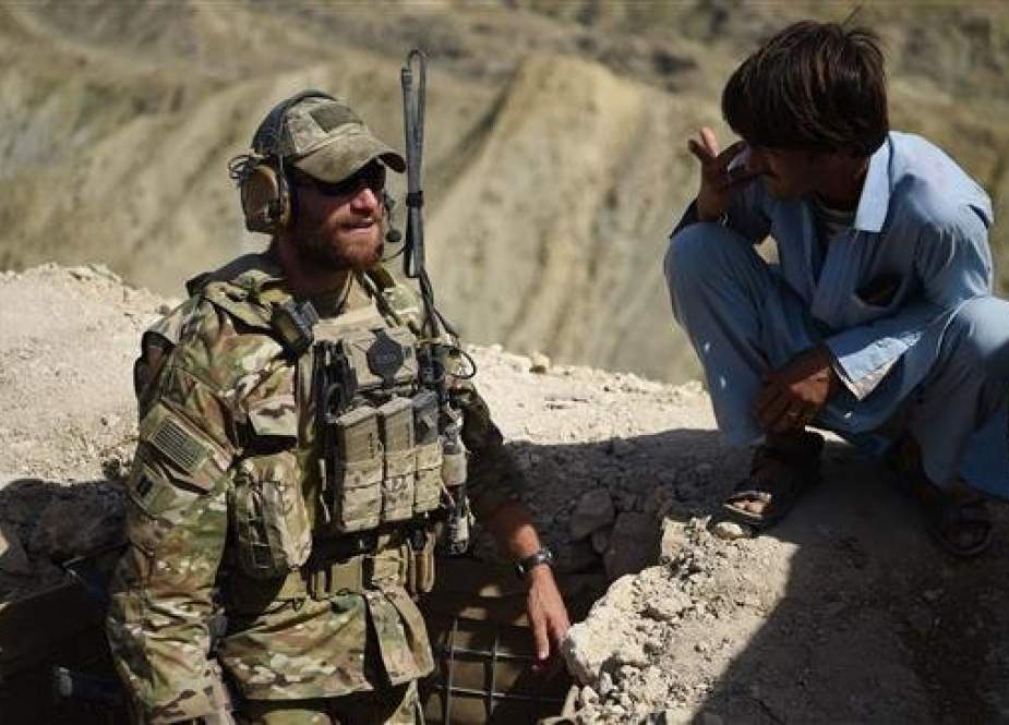 In this file photo taken on July 7, 2018, a US Army soldier from NATO and a member of Afghan Local Police (ALP) look on in a checkpoint during a patrol against Daesh Takfiri terrorists at Deh Bala district in the eastern province of Nangarhar. (AFP)