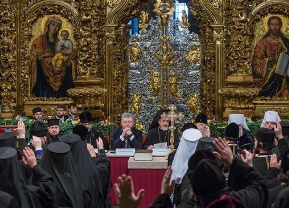 This handout picture, taken and released by the Ukrainian presidential press service, shows President Petro Poroshenko (C) attending a synod expected to establish an Orthodox church “independent” of Russia, in Kiev’s Saint Sophia Cathedral, on December 15, 2018. (Via AFP)