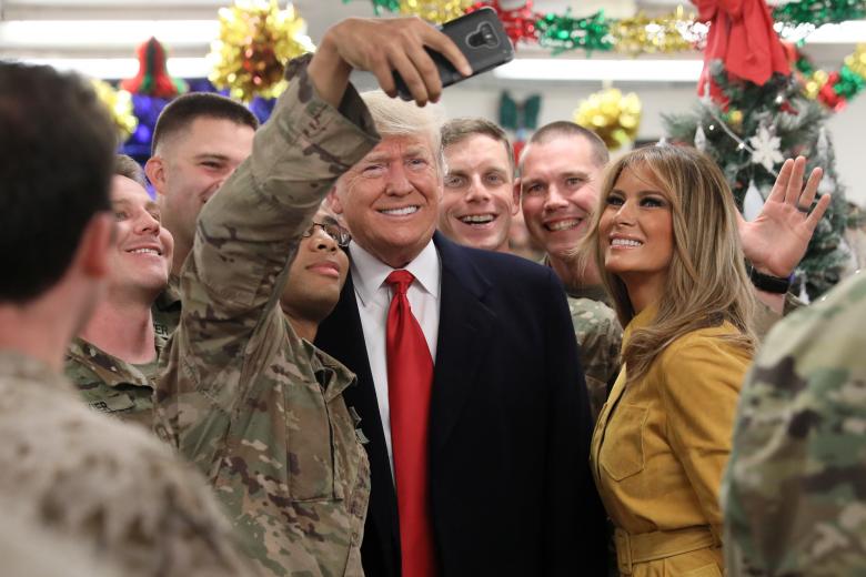 U.S. President Donald Trump and first lady Melania Trump greet military personnel at the dining facility during an unannounced visit to Al Asad Air Base, Iraq, December 26, 2018.