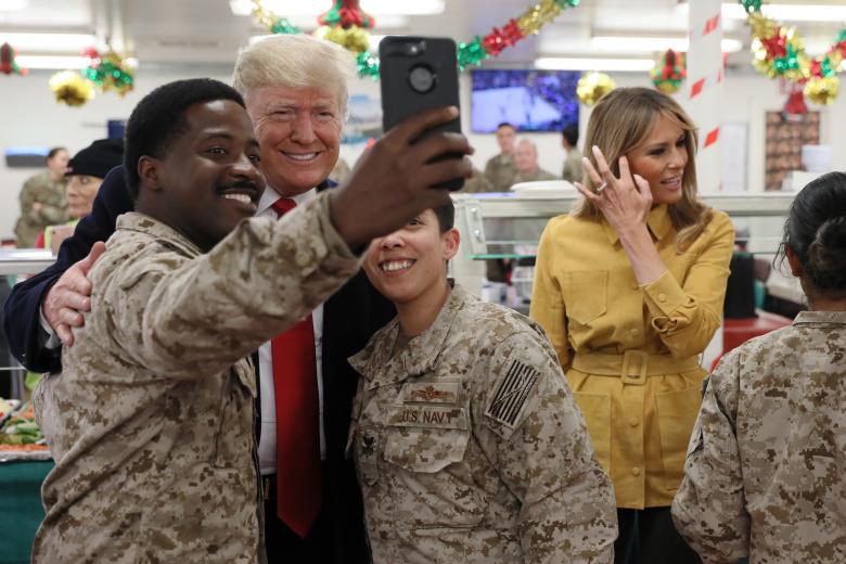 President Donald Trump and First Lady Melania Trump greet military personnel at the dining facility during an unannounced visit to Al Asad Air Base, Iraq.