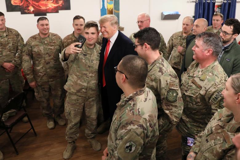 President Donald Trump and first lady Melania Trump greet military personnel at the dining facility during an unannounced visit to Al Asad Air Base, Iraq.