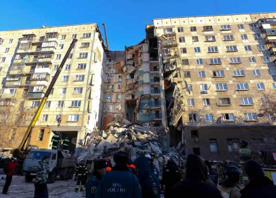 Emergency officers take part in a rescue operation after a gas explosion rocked a residential building in Russia